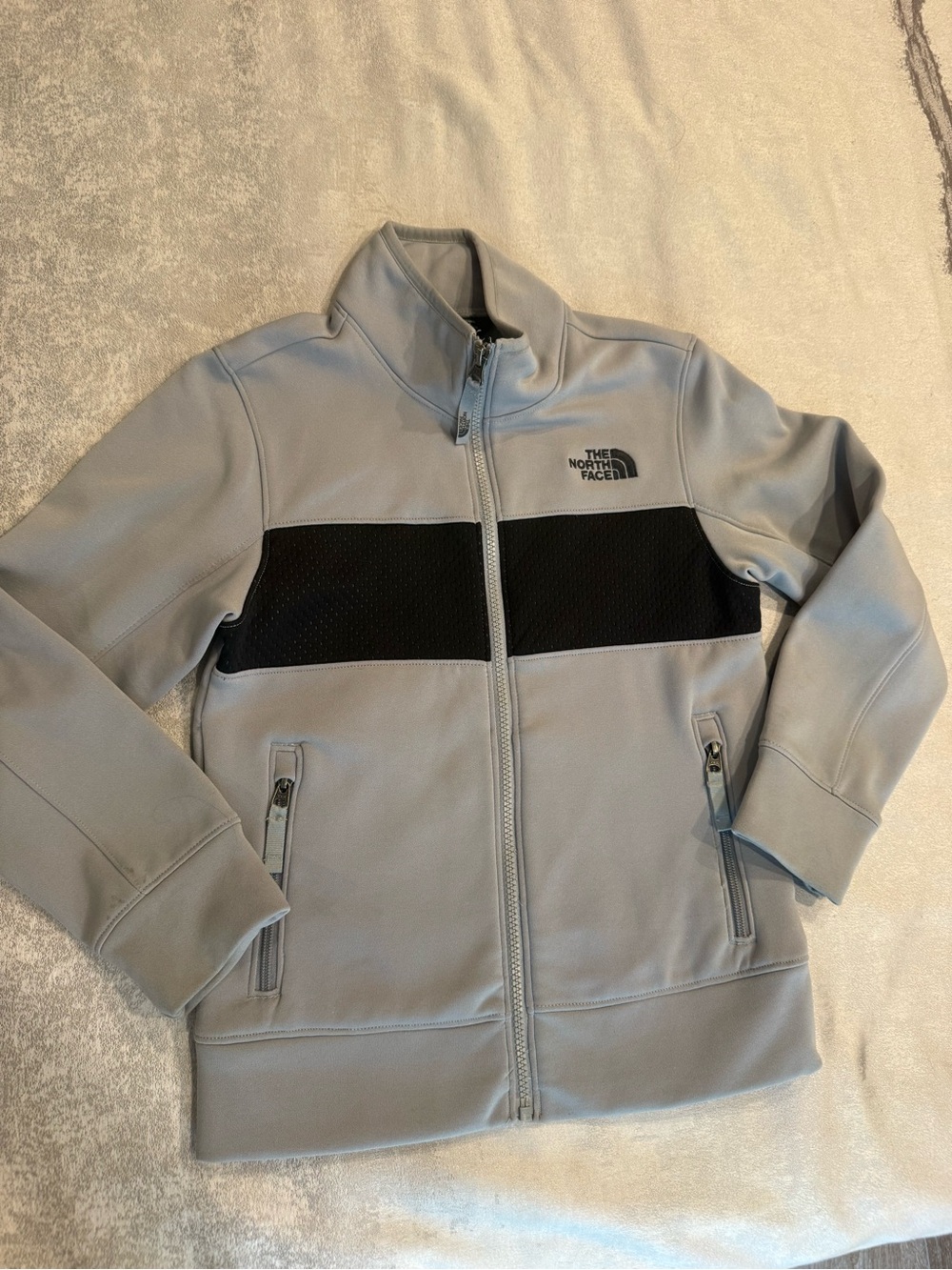 The North Face Kids’ Light Gray Jacket with Black Chest Stripe